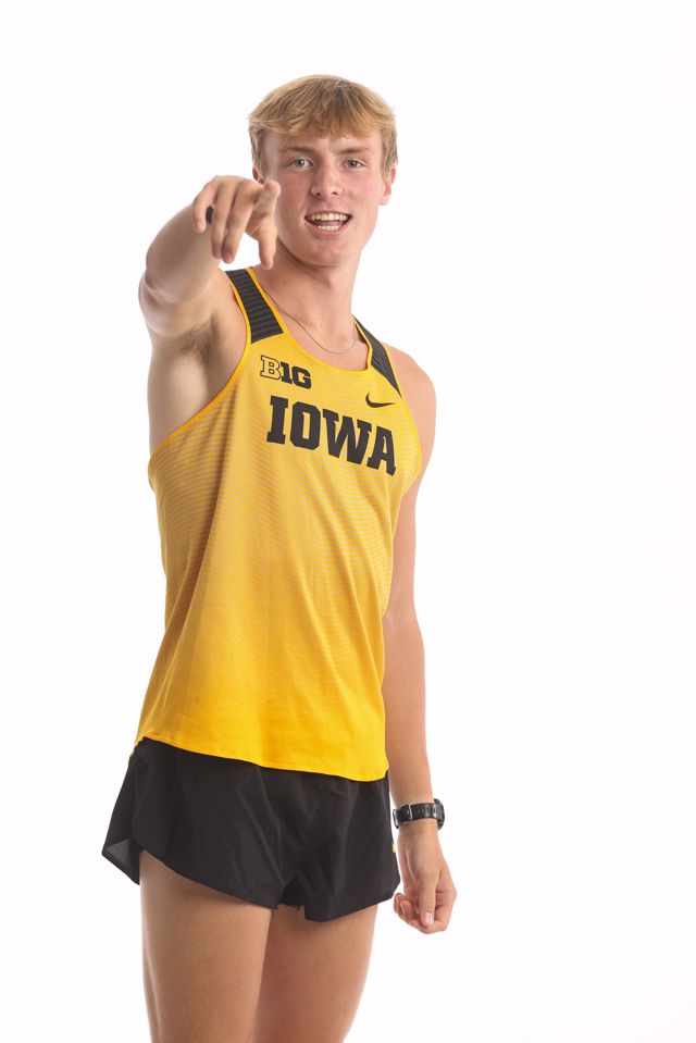Carson Houg pointing while wearing a yellow Iowa jersey