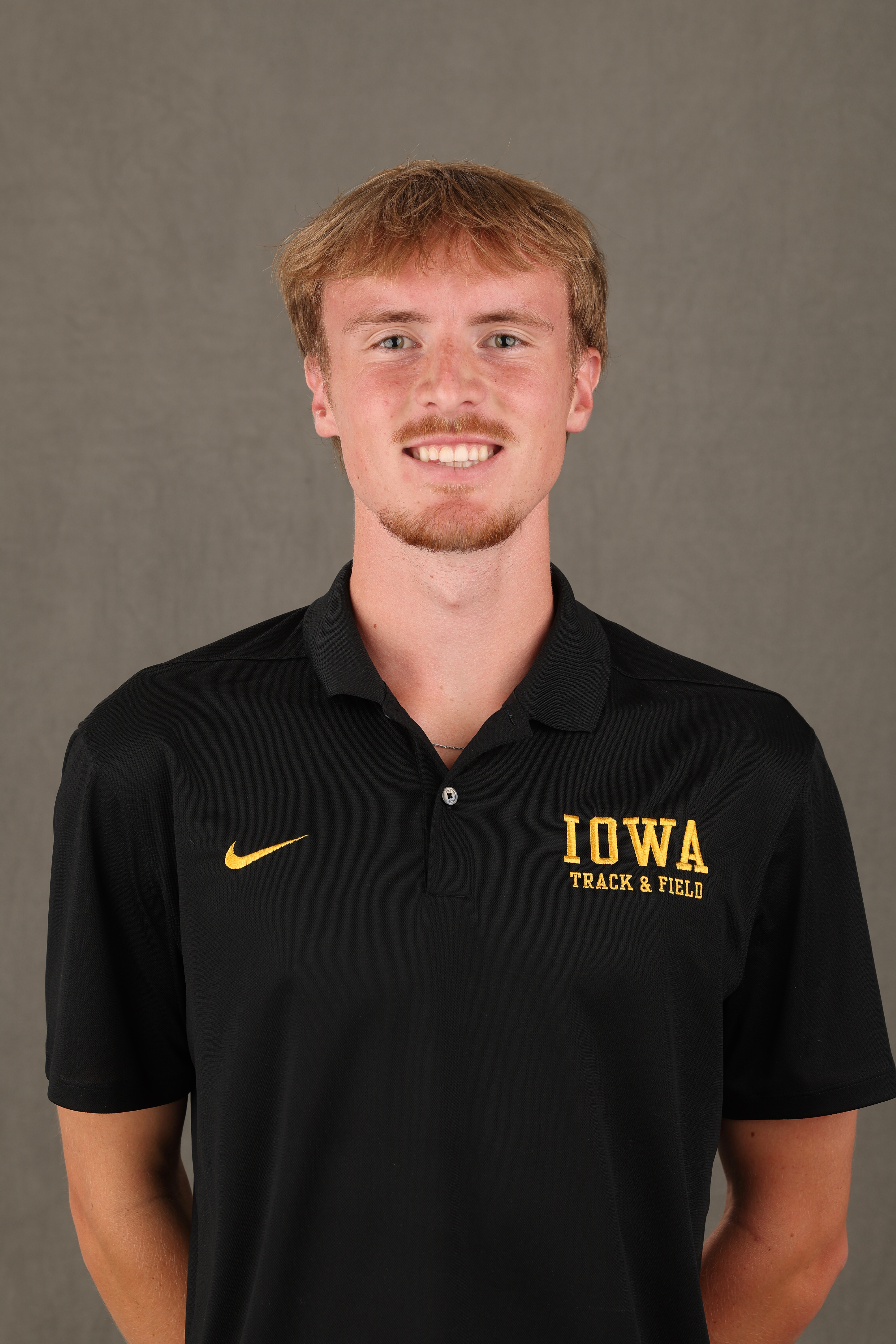 Carson Houg pointing while wearing a yellow Iowa jersey